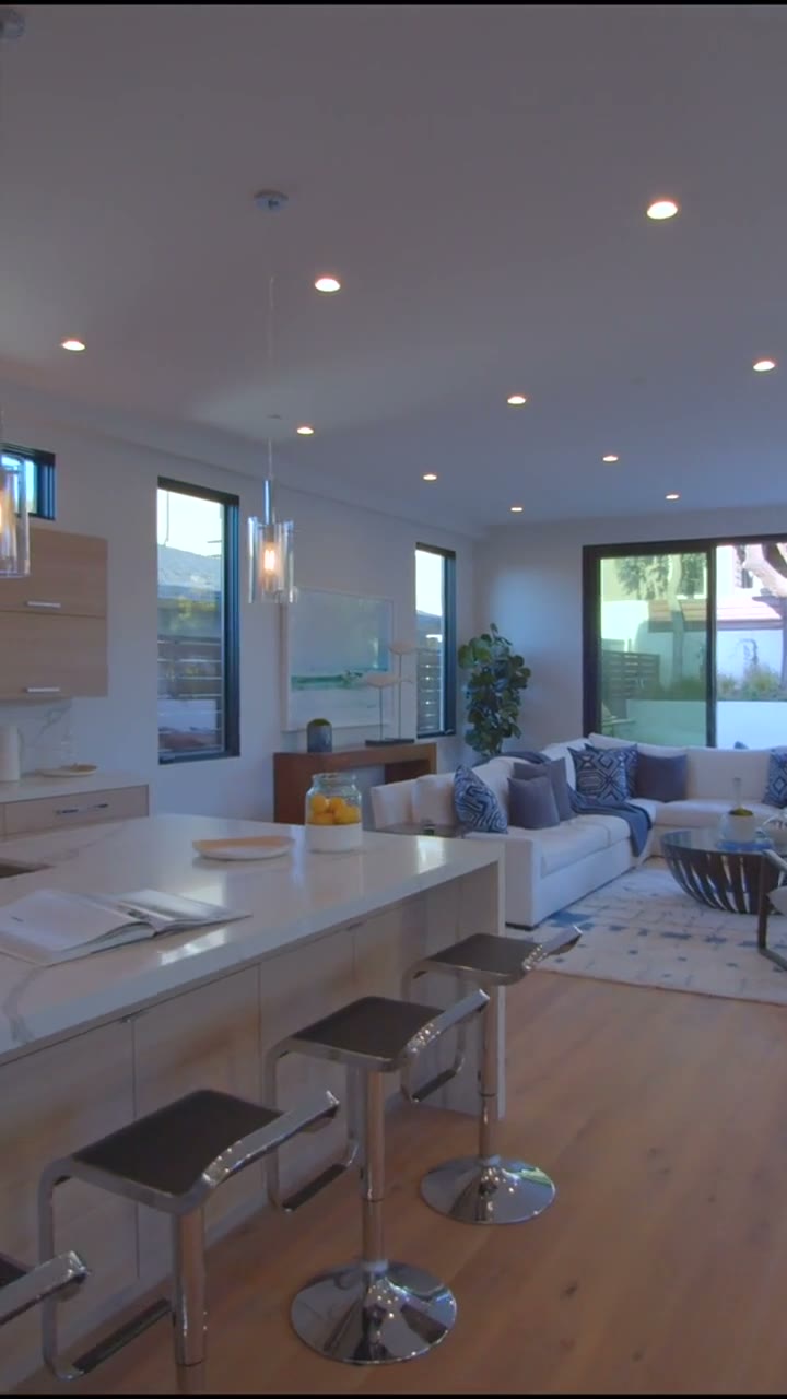 Open-concept living space with kitchen flowing into the lounge